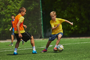 Outdoor Soccer Game. Teen boys in motion during soccer game, playing, raining on green field....