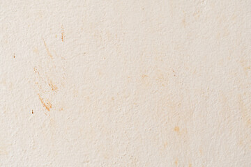Dirty concrete wall with red soil stains background. Grunge and rough surface. 