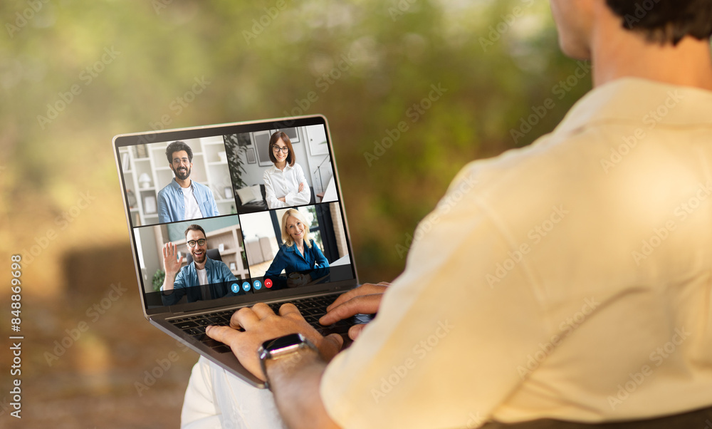 Poster a man is holding a laptop with a screen displaying a group of people. the individuals on the laptop 