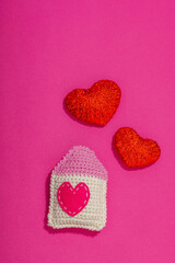 Handmade Valentines Day concept. Creative house figurines, traditional hearts, spring crocheting