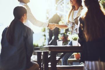 Business people, team and handshake or happy at cafe for welcome, b2b networking or remote work outdoor. Collaboration, employees and shaking hands with hello for onboarding, partnership or agreement