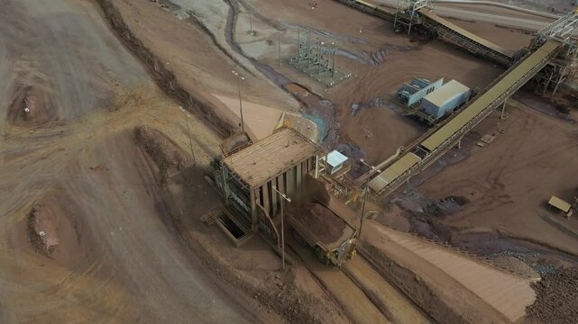 Aerial view of a nickel mine where a huge truck is unloading.