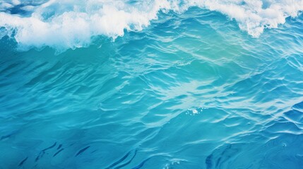 Obraz premium close-up tropical beach water pattern background with vibrant blue water, sunlight dancing on the waves, and a sense of adventure and exploration