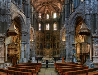 view of the central nave and altar with gilded altar piece in the Avila Cathedral