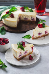 Cheesecake with raspberries. A piece of cheesecake with raspberries and mint.