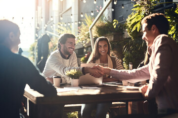 Business people, men and shaking hands in meeting at cafe for welcome, b2b networking or collaboration outdoor. Group, employees and handshake for onboarding, partnership deal and happy for agreement