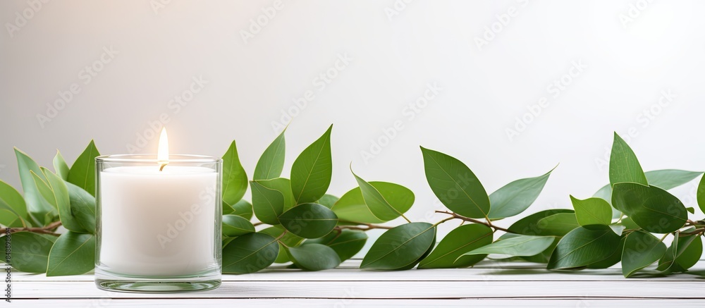 Poster candles placed in a vase with green leaves creating a beautiful decoration on a white table with cop