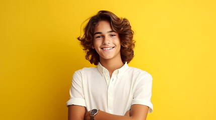 Obraz premium Happy cheerful young latino generation z. Smiling ethnic cool generation z teenage student, long hair, yellow background.