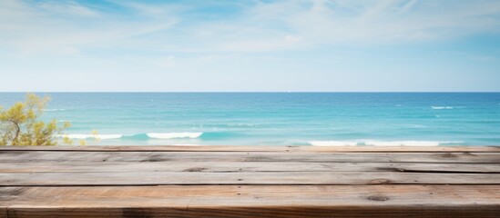 Rustic wooden tabletop on a beach backdrop for summer advertising with empty copy space image available for customization