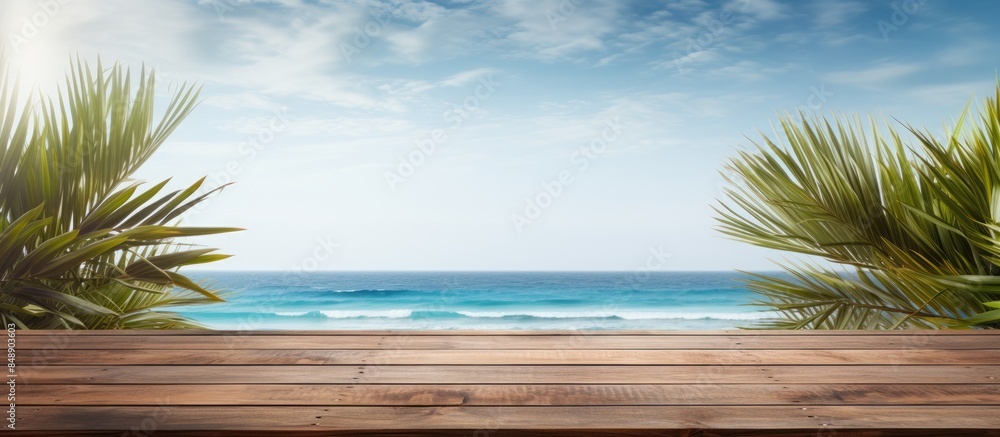 Poster wooden planks with ocean backdrop and palm leaves in the front creates a versatile copy space image 