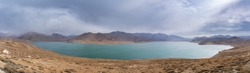 Scenic moody landscape panoramic view of Yashilkul lake in high altitude Pamir mountains, Gorno-Badakhshan, Tajikistan