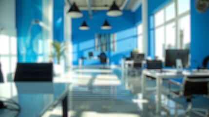 Blur background of modern office lounge decorated with blue walls, wooden table, glass partitions, and plants. Contemporary workplace design concept. Design for poster, wallpaper, banner. Spate.