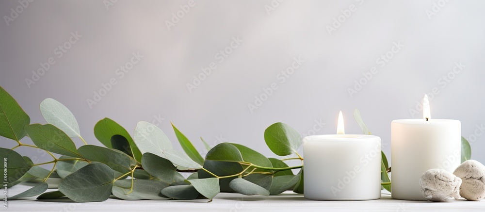 Poster candles placed in a vase with green leaves creating a beautiful decoration on a white table with cop