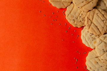 Assorted delicious carrom seed cookies or salted ajwain cookies on an orange background. Top view.