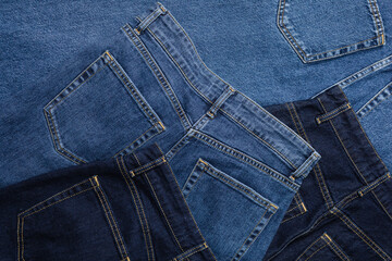 Close-up of blue jeans back pockets in various shades of blue denim.