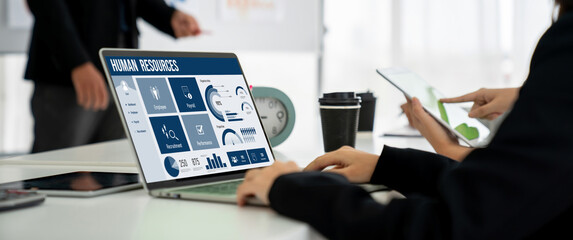 Human resources management software on computer screen helping human resources employee to manage...