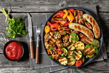 grilled white sausages with veggies and mushrooms