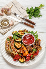 grilled white sausages with veggies and mushrooms