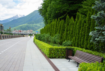 Rosa Khutor embankment, mountains and green forest. Krasnaya Polyana, Sochi.