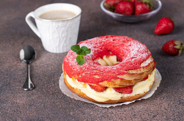 French cake Paris-Brest made from choux pastry, strawberry and custard