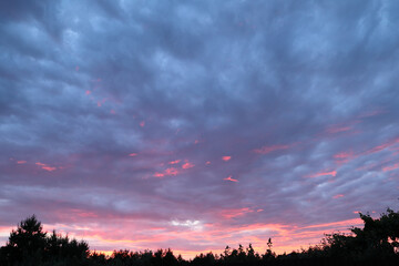 Majestic sundown sky background with gentle colorful clouds. Orange, Yellow and purple sunlight on Golden hour