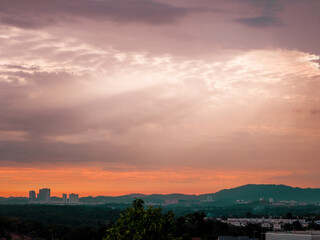 Sunrise over suburban city. Skyline view of cityscape with sunlight and flare in warm light color tone.