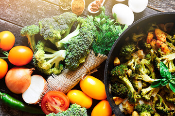 chicken and broccoli - vegetable sauté, fresh broccoli and orange tomatoes, chicken,  mushrooms, carrots and potatoes. organic and vegan food kitchen	