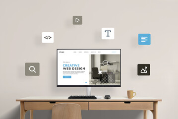 Work desk with computer display featuring web design studio presentation page, surrounded by flying web design icons. Visual representation of a creative digital workspace concept