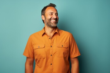 Fototapeta premium Portrait of a satisfied man in his 40s sporting a breathable hiking shirt isolated in solid color backdrop