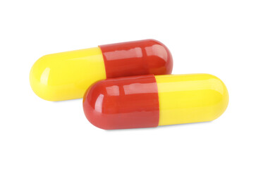 Two antibiotic pills isolated on white. Medicinal treatment
