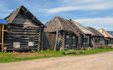 Village street in the taiga village of Nikolaevka in the Southern Urals on a sunny summer day