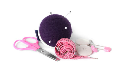 Pincushion, needles and other sewing tools isolated on white