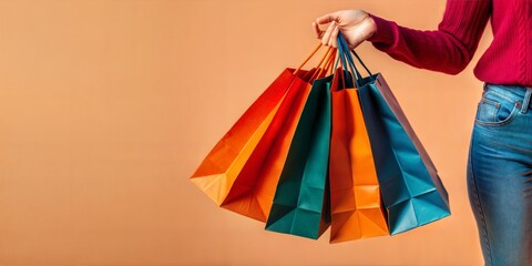 A woman's hand with packages from a shopping center.