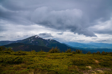 Wonderful nature. Rocky land, high mountains, dramatic sky.