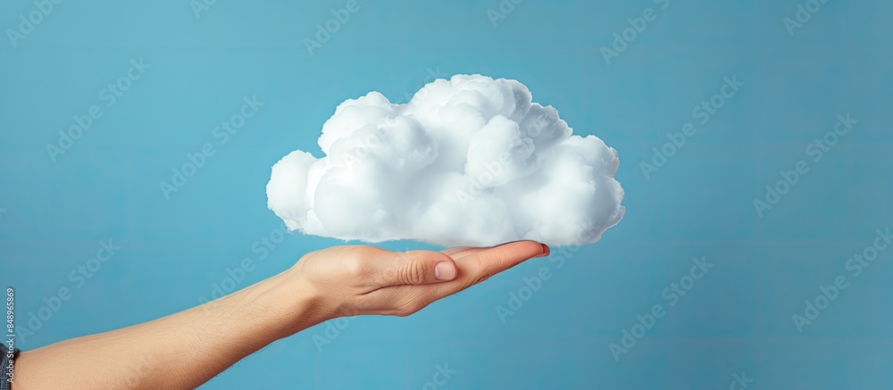Poster hand holding a cloud over a blue background illustrating cloud storage and computing concept with a 