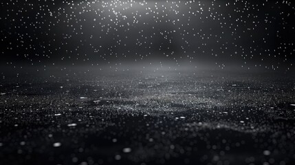 A black abstract background with a subtle gradient into deep charcoal, featuring silver particles that mimic a gentle rainfall in a dark night sky.