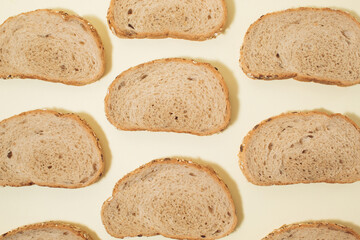 Arranged slices of wheat dough bread with seeds on top, food texture