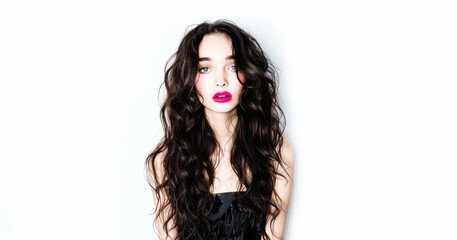 Naklejka premium Portrait of a sensual brunette on a white wall.