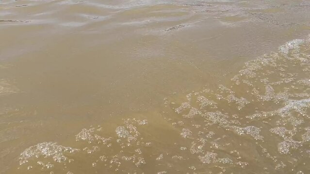 Water waves and foam following the boat in transportation route.