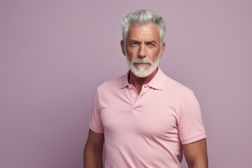 Obraz premium Portrait of a content man in his 50s donning a classy polo shirt in solid pastel color wall