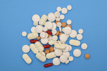 Conjunto de muchas pastillas con un fondo azul, concepto de salud.