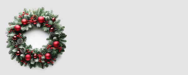 Christmas round wreath with red decorative balls. White background, empty space for text. A Christmas banner.