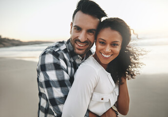 Couple, hug and sunset at beach with portrait for care, love or connection for holiday in Brazil. Man, woman and embrace on vacation, date and outdoor in nature by ocean, excited or smile in sunshine