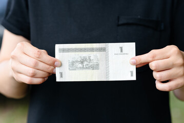 close-up view of cuban peso, young woman holds paper bill in hands, national currency concept