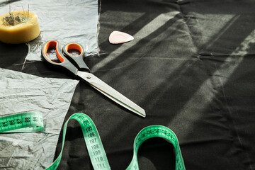 Tools for tailor work on the table. Process of sewing linen suit. Empty space