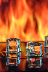 three ice cubes against the background of fire, fire and ice, place under the text 2