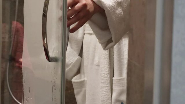Woman remove water with shower squeegee from glass door. Housekeeping and cleanliness. 4k high quality video. 