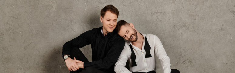 A loving gay couple in elegant suits share a tender moment.