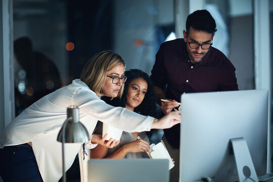 Night, collaboration and business people with computer and food at web design job with teamwork. Internet, technology and discussion of project management of company website update in office