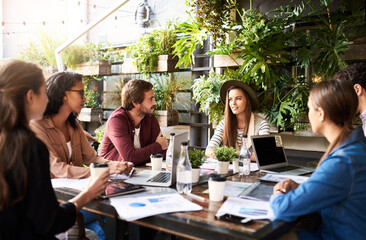 Creative, ideas and people in cafe for planning, strategy and online startup project development with teamwork. Collaboration, men and women in coffee shop with laptop, paperwork and design meeting